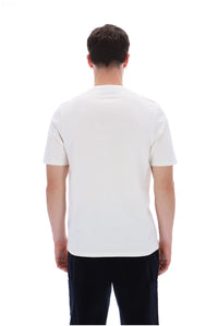 A man viewed from behind wearing a plain white short-sleeve crewneck t-shirt and dark pants, set against a solid white background.