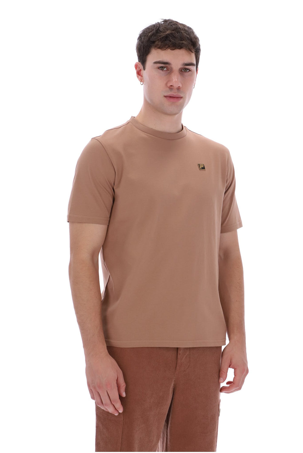 A man wearing a short-sleeve crew-neck t-shirt in a warm tan-brown color, paired with matching brown pants, photographed against a solid white background.
