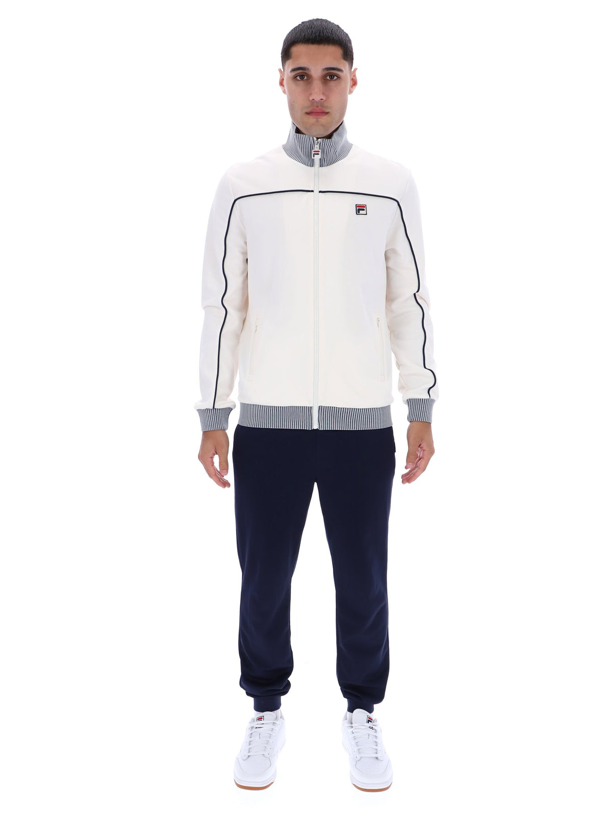 Displays a model wearing the Gardenia 'FILA' branded Zayn Track Top