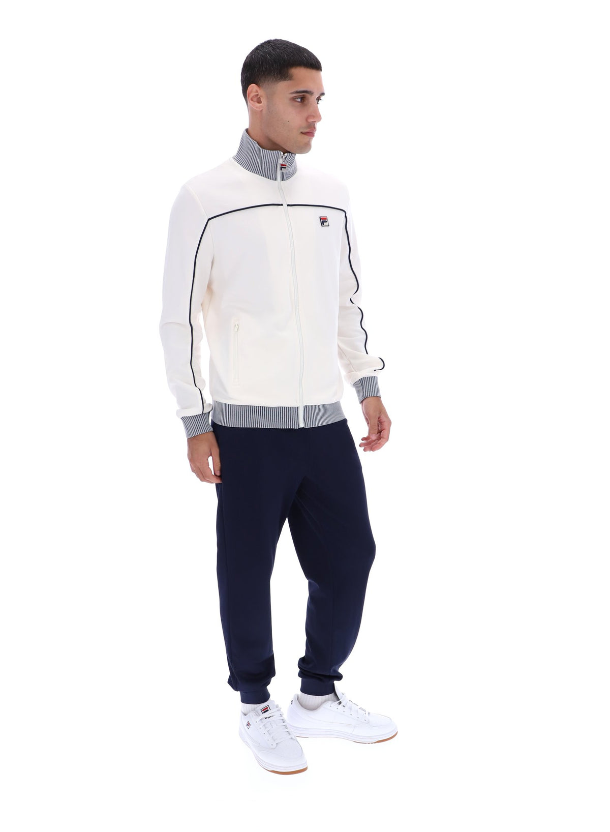 Displays a model wearing the Gardenia 'FILA' branded Zayn Track Top