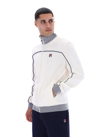 Displays a model wearing the Gardenia 'FILA' branded Zayn Track Top