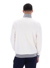 Displays a model wearing the Gardenia 'FILA' branded Zayn Track Top