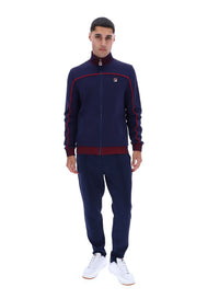 Displays a model wearing the Navy 'FILA' branded Zayn Track Top