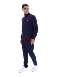 Displays a model wearing the Navy 'FILA' branded Zayn Track Top