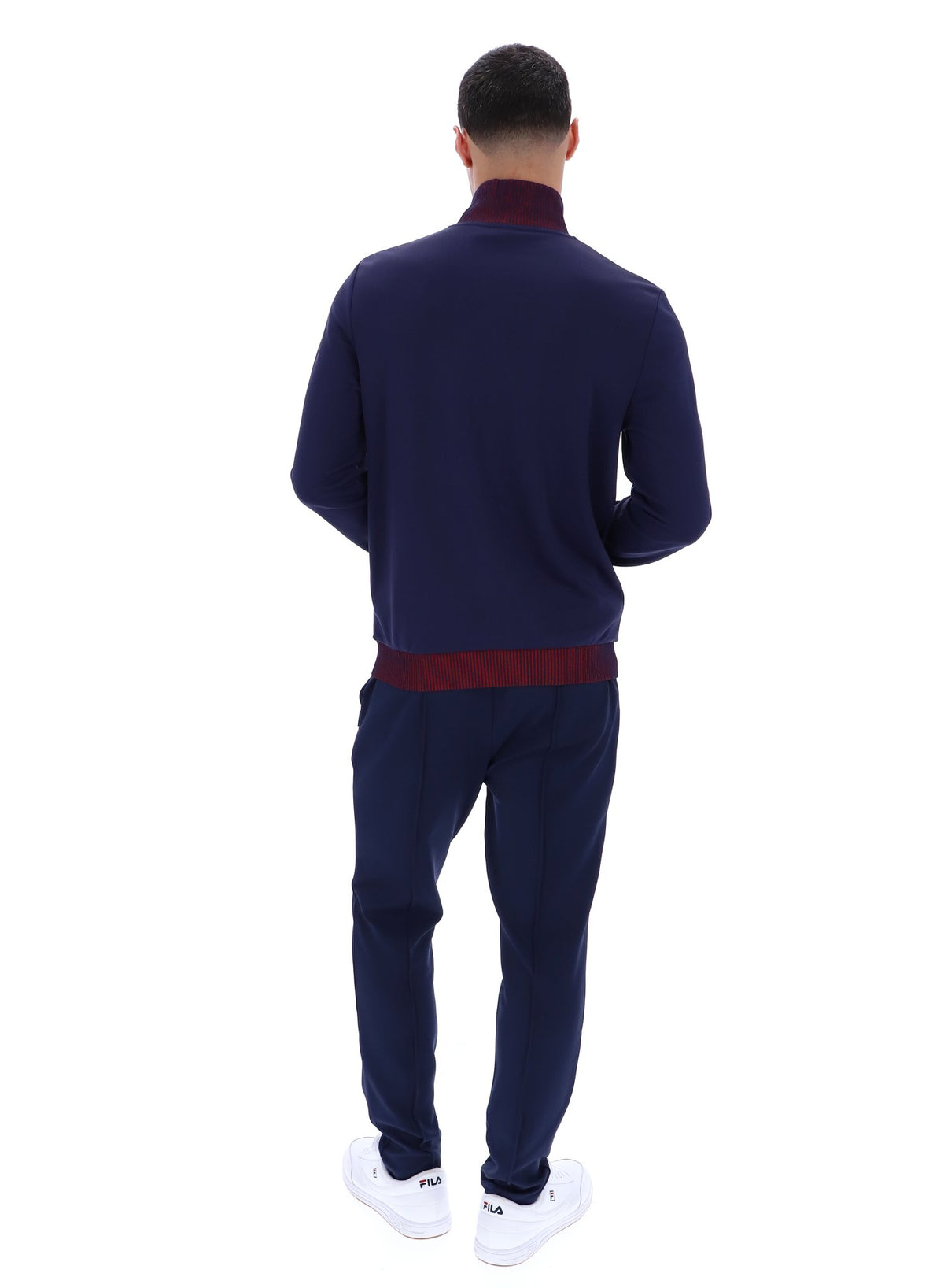 Displays a model wearing the Navy 'FILA' branded Zayn Track Top