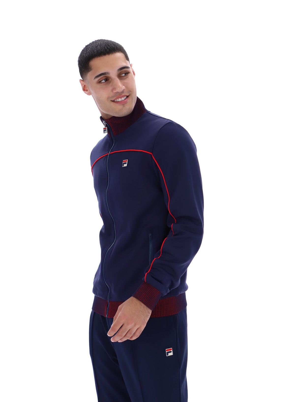 Displays a model wearing the Navy 'FILA' branded Zayn Track Top