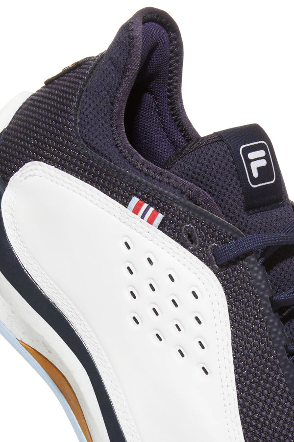 A pair of FILA Mondo Forza Tennis Trainers in white and navy colour scheme.