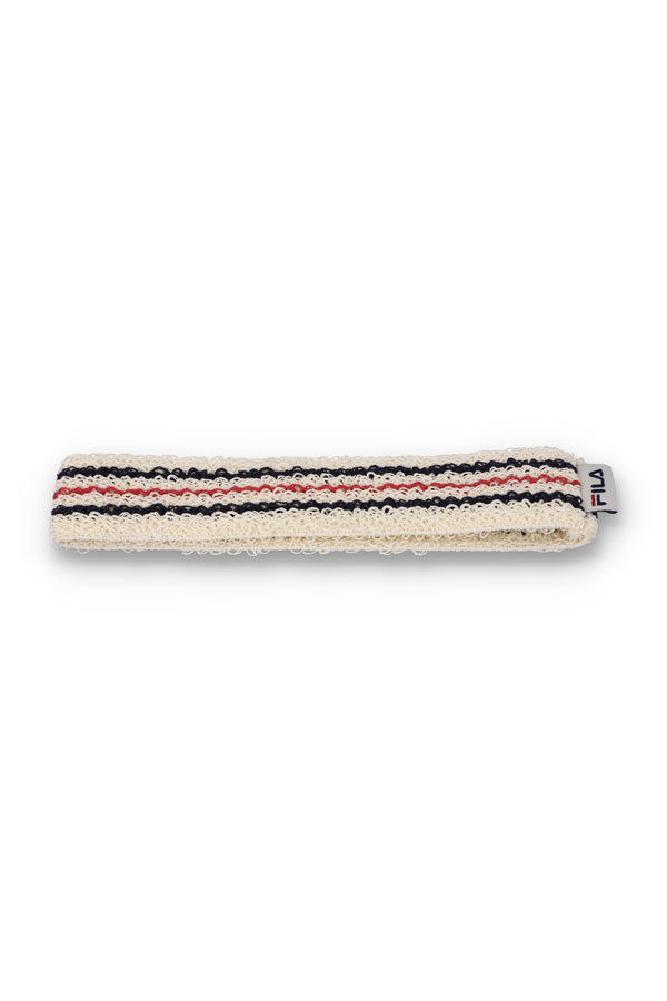 A beige retro headband with a red and blue stripe pattern and the FILA logo embroidered on it.