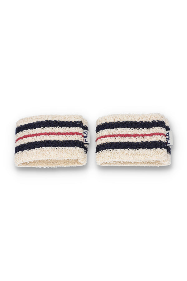 A pair of beige, red, and blue striped retro wristbands with the FILA logo.
